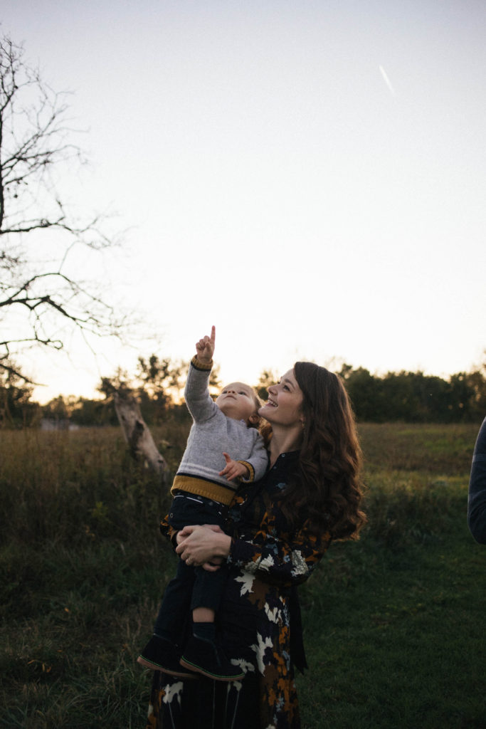 Naperville Illinois Forest Preserve family lifestyle session, mother holding her son pointing to the sky at the moon