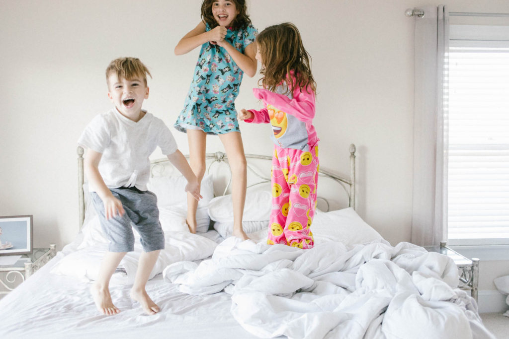 On Saturday's we wear pajamas in New Lenox, IL, Photos by Elle Baker Photography, three little kids jumping on the bed