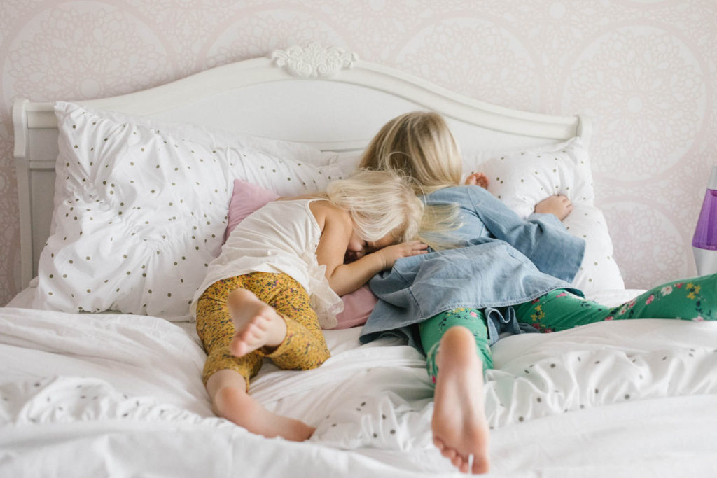 In home lifestyle session, Photos by Elle Baker Photography, Chicago photographer, two little girls sitting on a bed 