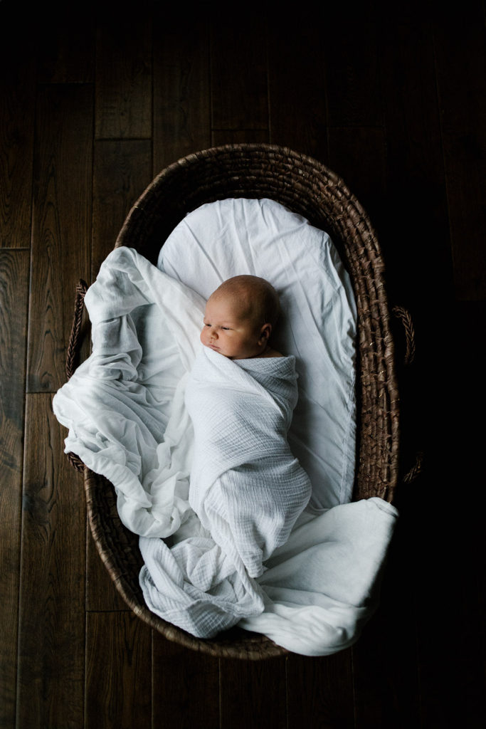 Chicago lifestyle newborn photographer | Photo by Elle Baker Photography | Moses basket and newborn in white wrap