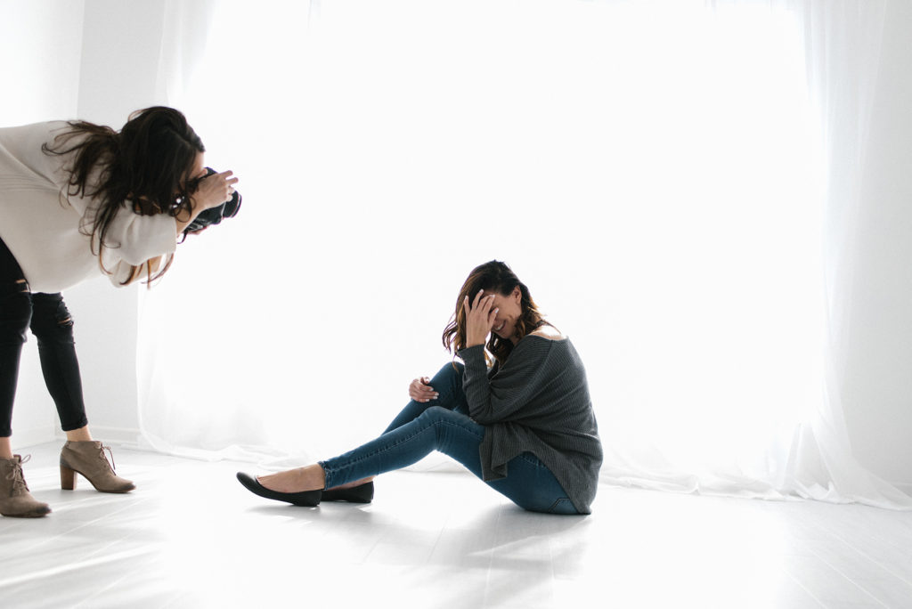 Laurie Baker is one of Chicago's Top Newborn Photographers at Elle Baker Photography. This image shows Laurie behind the scenes photographing a woman's headshots