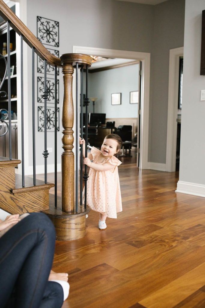 Naperville family photographer photographs baby girl in peach dress