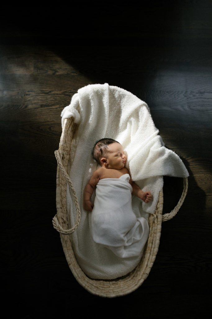 Downers Grove newborn photographer, Laurie Baker captures natural and simple image of a newborn in a Moses basket