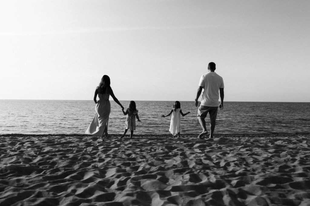 beautiful black and white image of family at the beach 