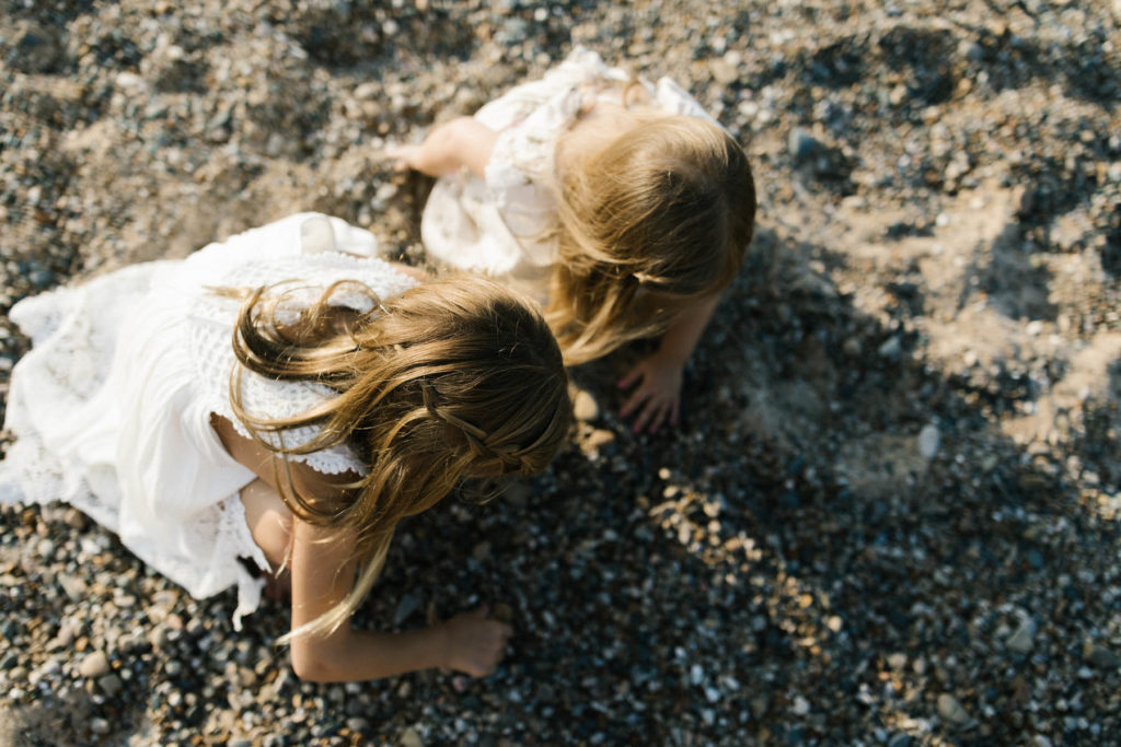 two little girls searching for sea shells during beach session 