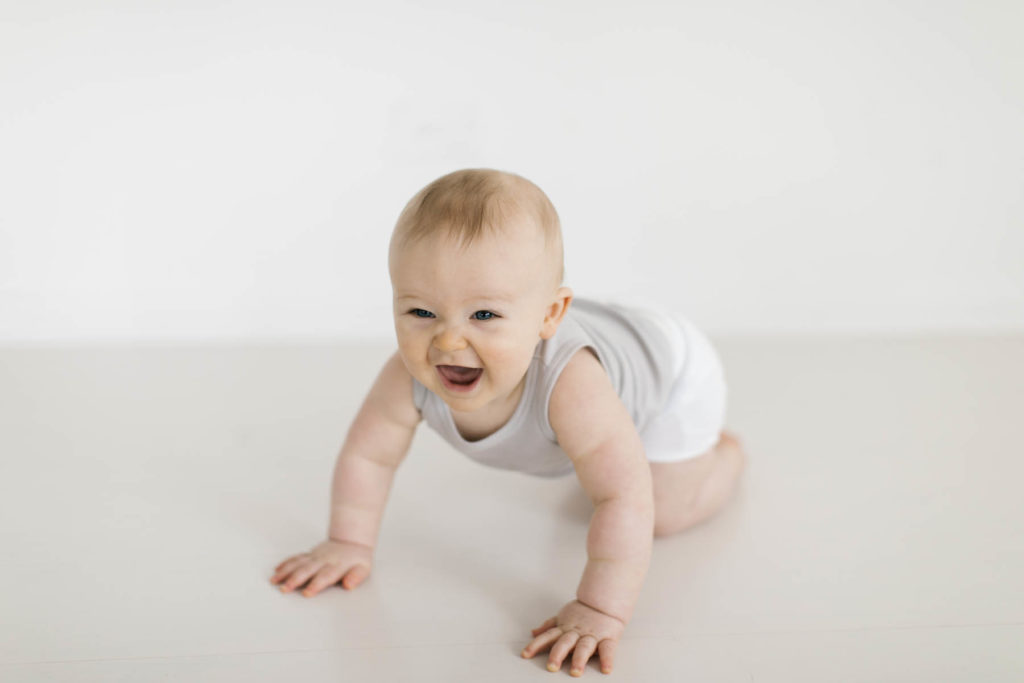 baby laughing and crawling in Homer Glen, IL photography studio 