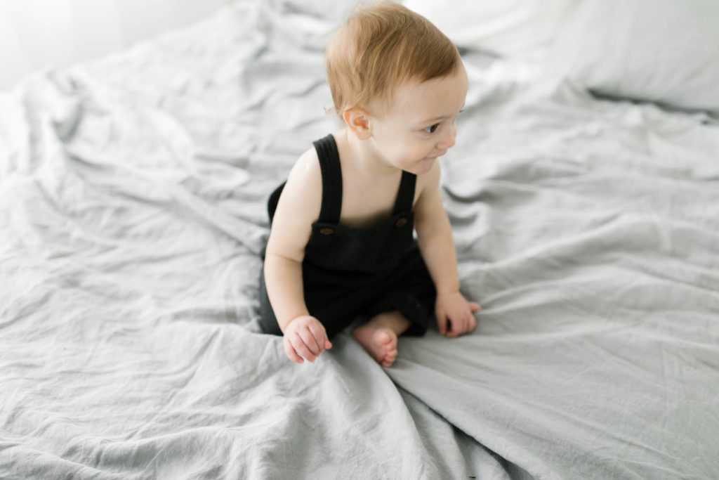 first birthday photo session with baby boy crawling around 