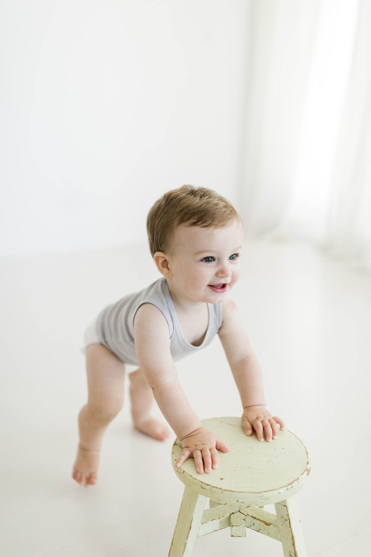 baby boy smiling in white studio 