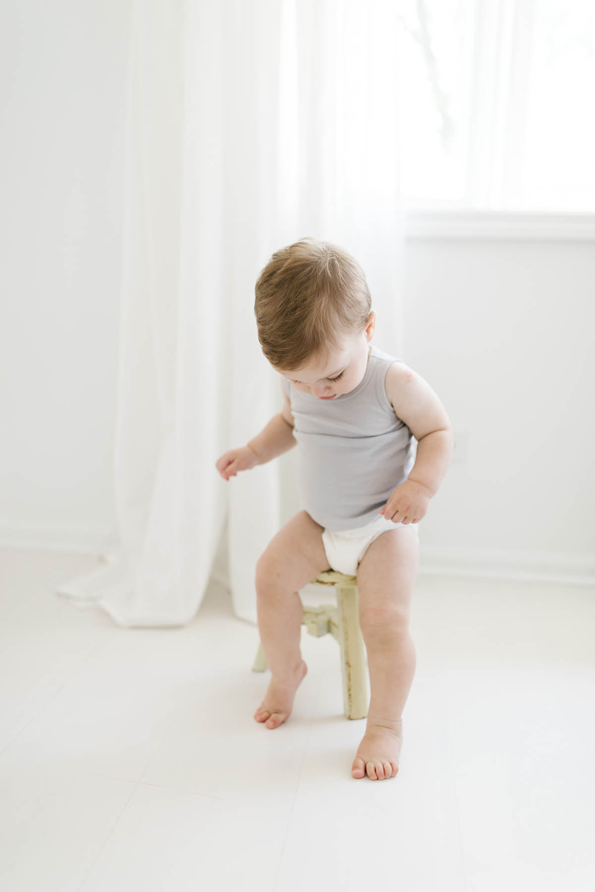 Laurie captures baby boy sitting on stool first birthday photo shoot