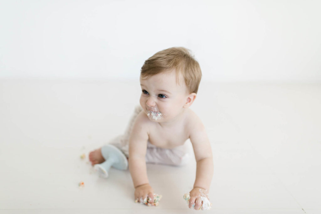 cake smash session with baby boy during first birthday photo shoot 