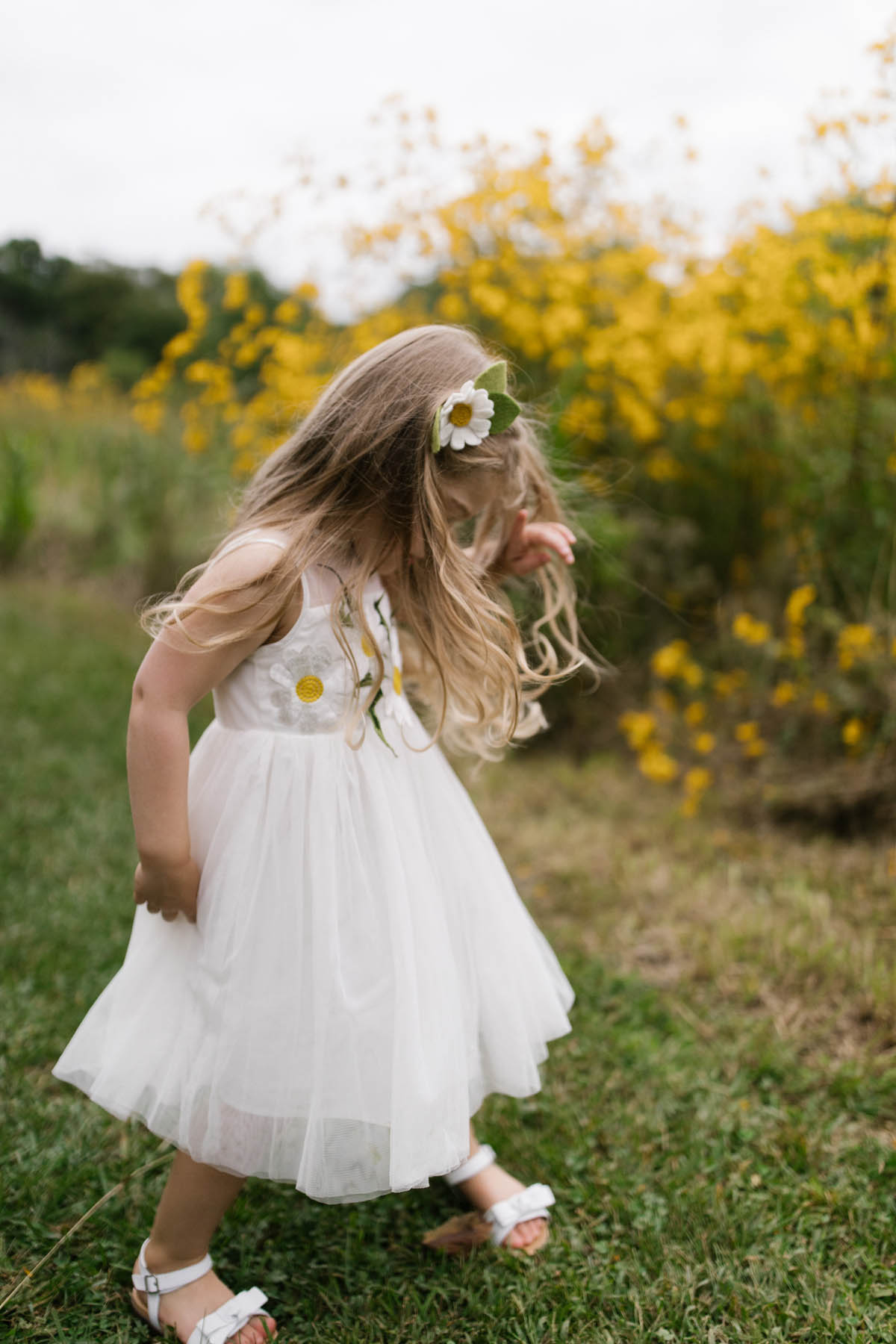 little girl with long blonde hair twirling 