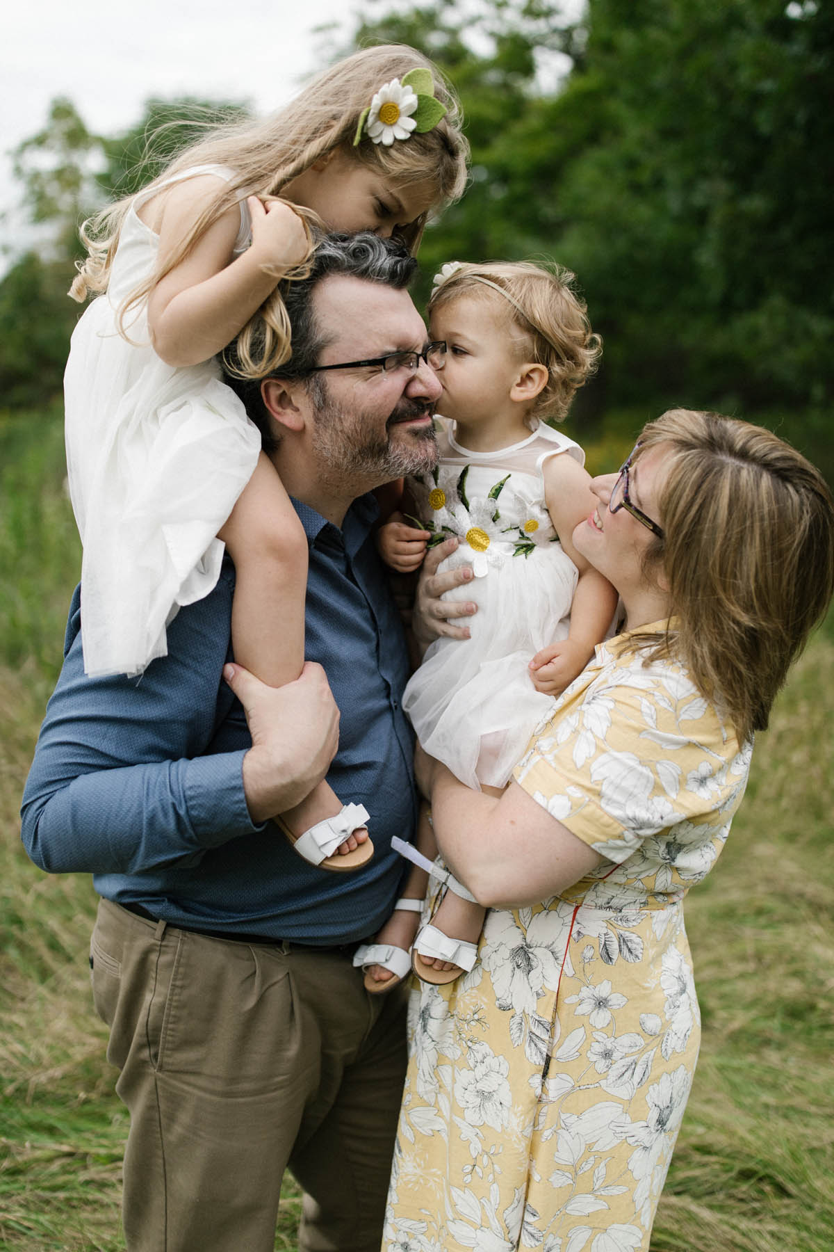 baby girl kissing dad during family session 