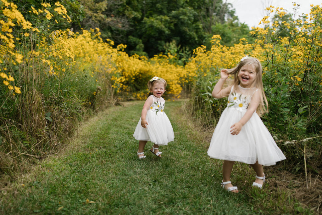 blonde girls twirling during storytelling family photography session 