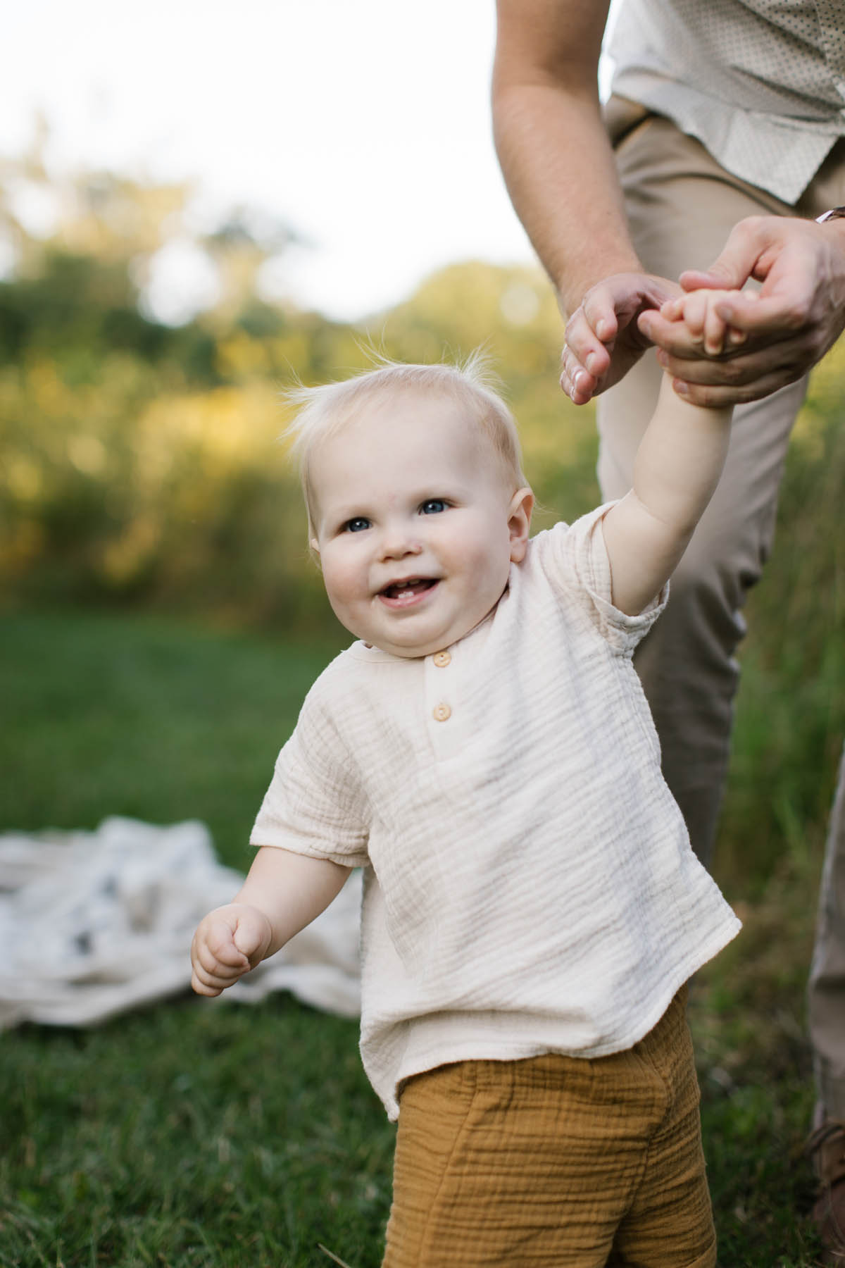 twelve month old baby boy wearing neutral clothing 