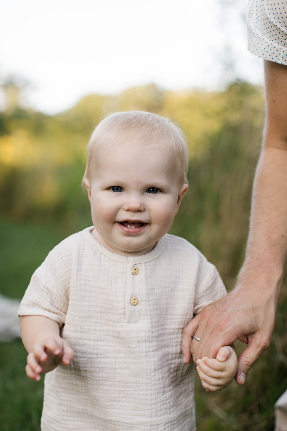 baby boy smiling at camera during fall family session 