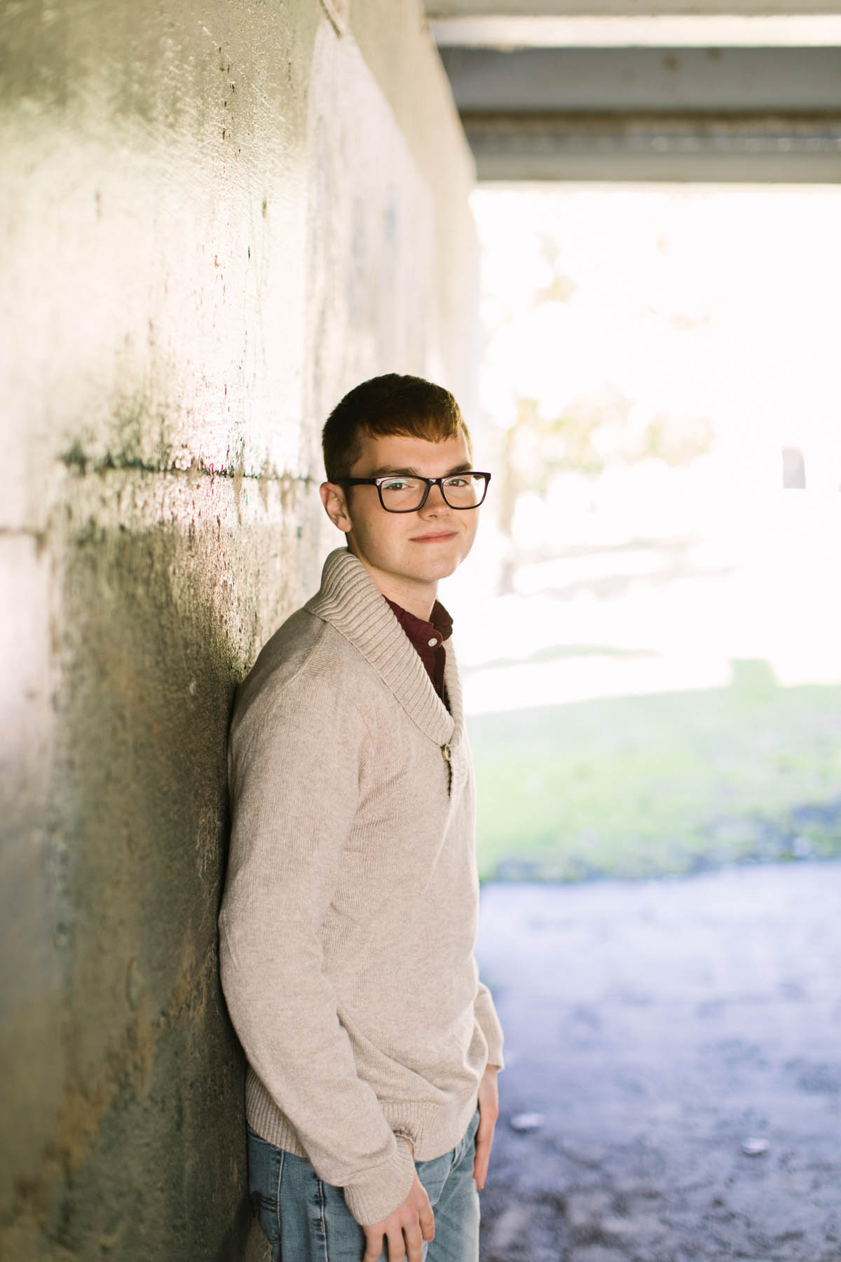 High school senior photography photo of boy in tan sweater