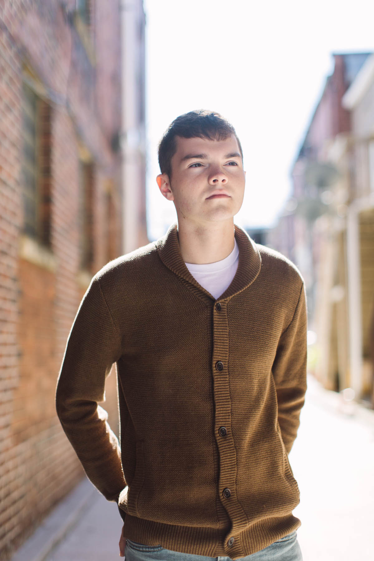high school senior portraits with boy in brown sweater 