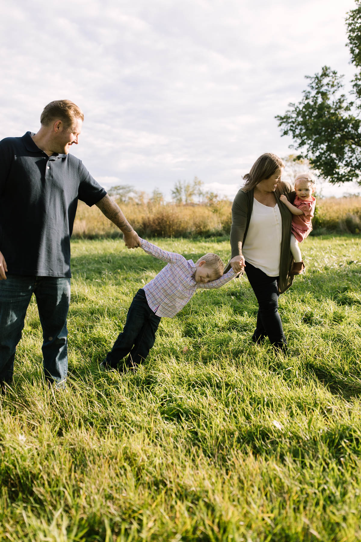 family of four running in a field together 