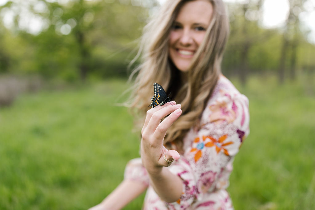 young girl holding a beautiful butterfly