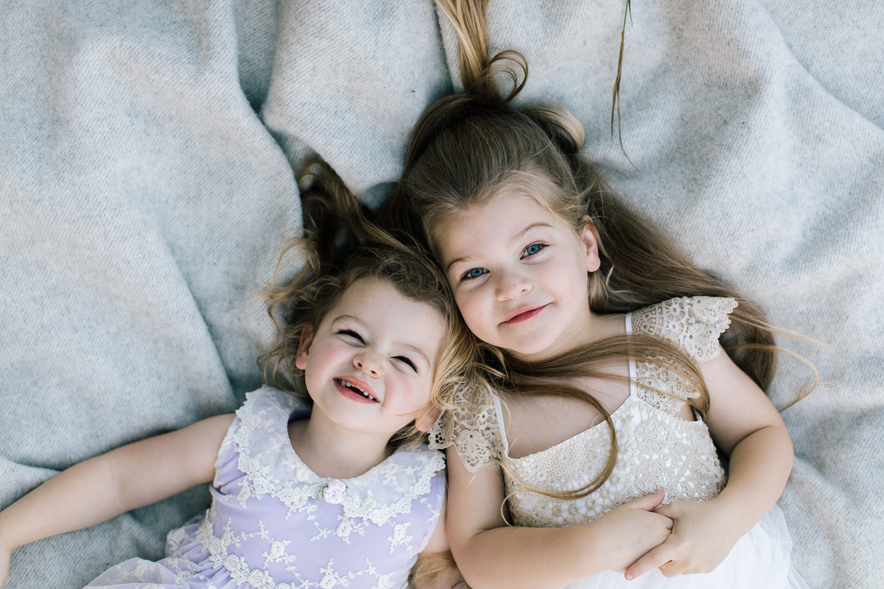 two little girls smiling into the camera 