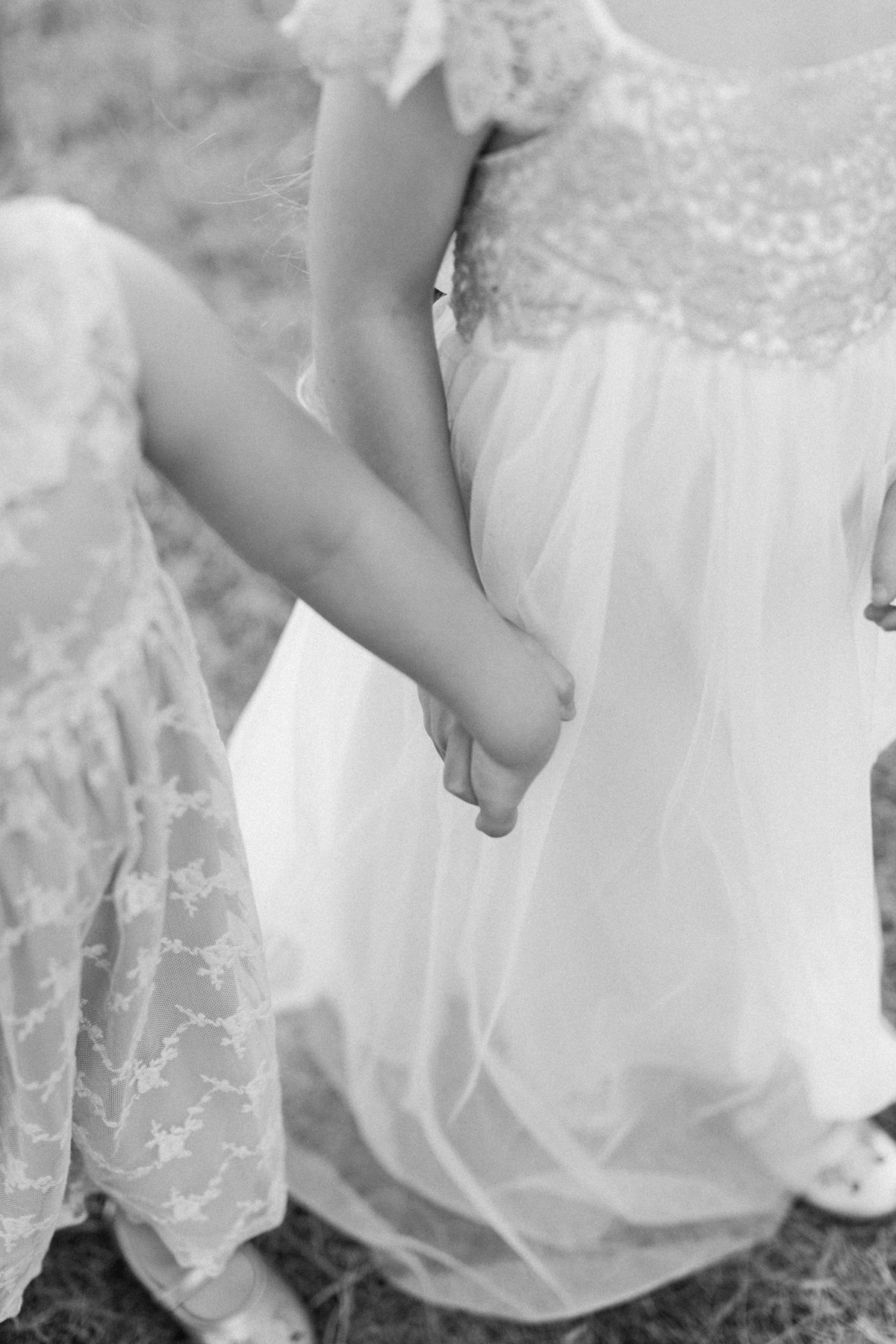 two sisters holding hands in black and white image 