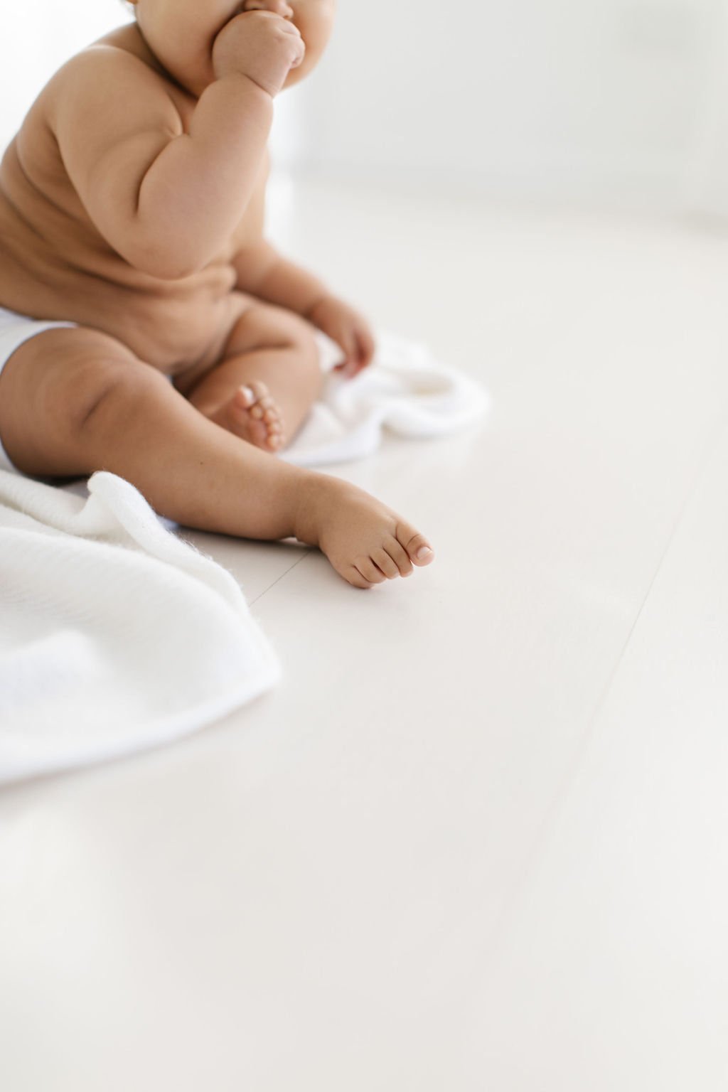 close up photo of baby's tiny feet in a white photography studio 