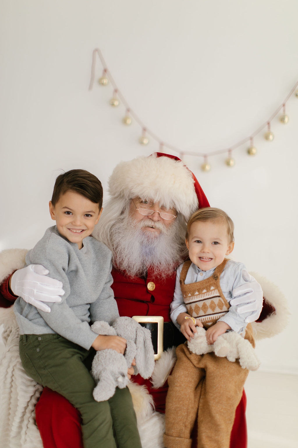 two boys taking pictures with Santa Claus at Homer Glen studio 
