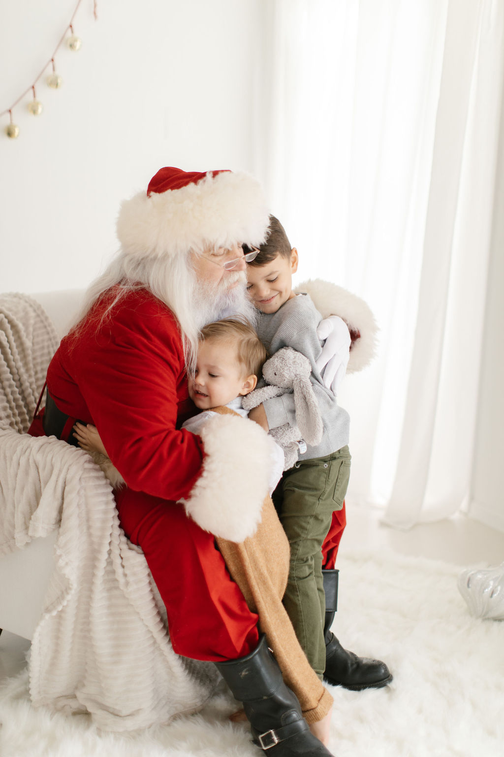 kids hugging Santa during photo session
