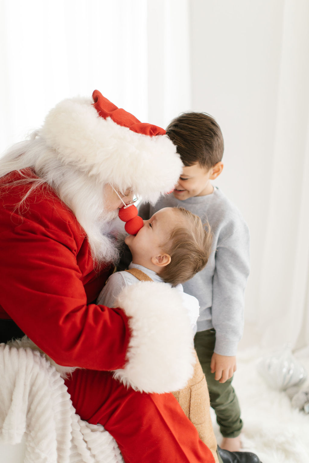 Kids pretending to be Rudolph during photo session with Santa 
