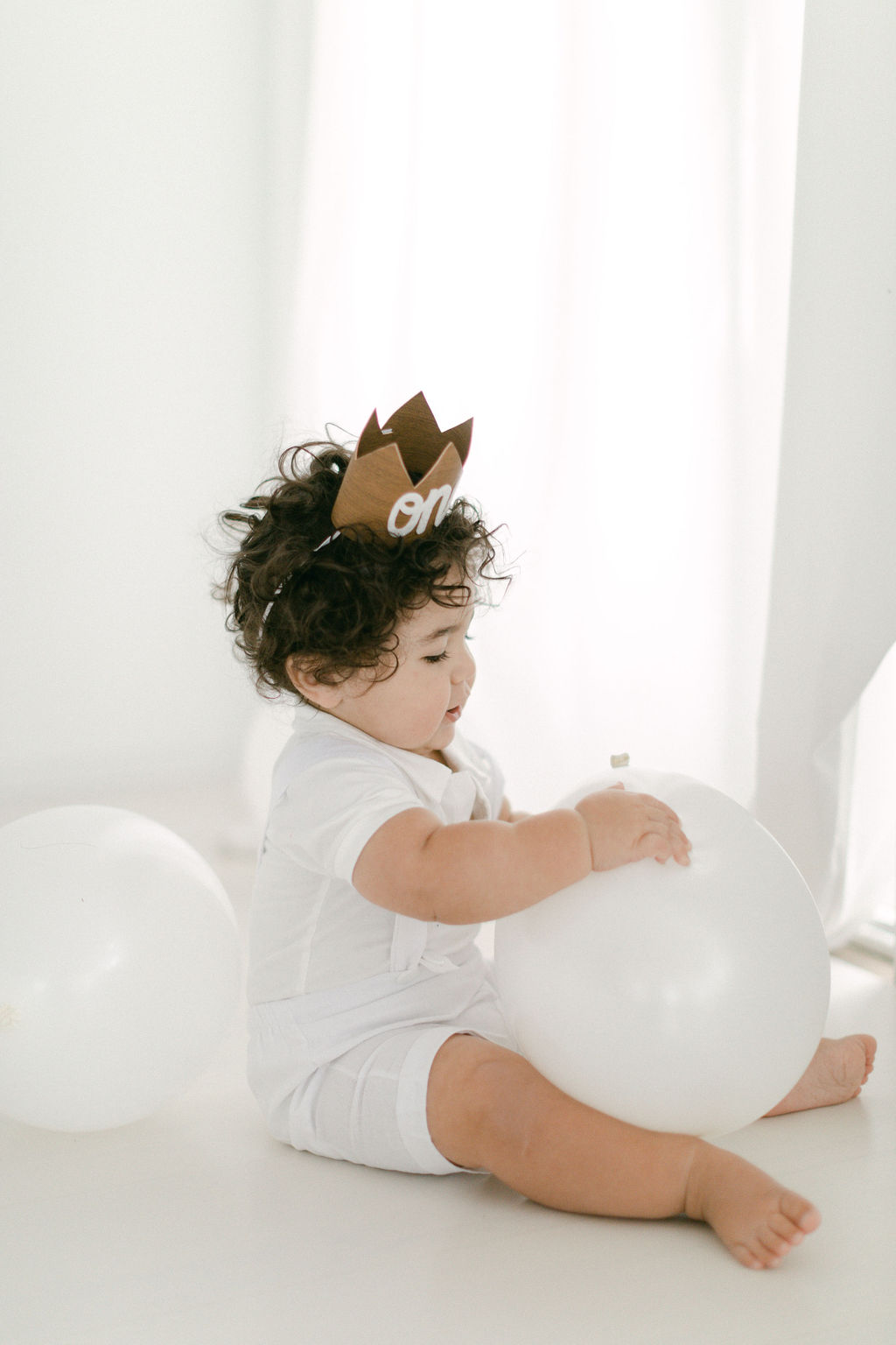 baby with a one year old crown on during photoshoot 