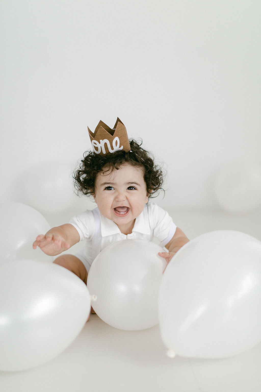 happy baby laughing during first birthday photography session