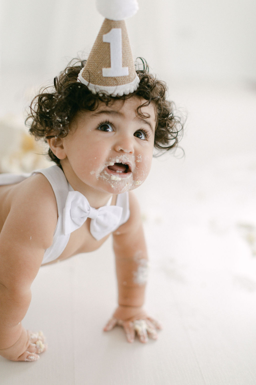 happy baby during cake smash and cone hat